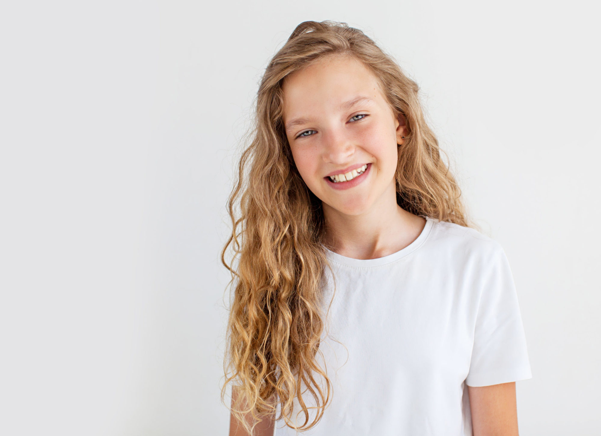 Portrait smiling young girl. Teen at white background